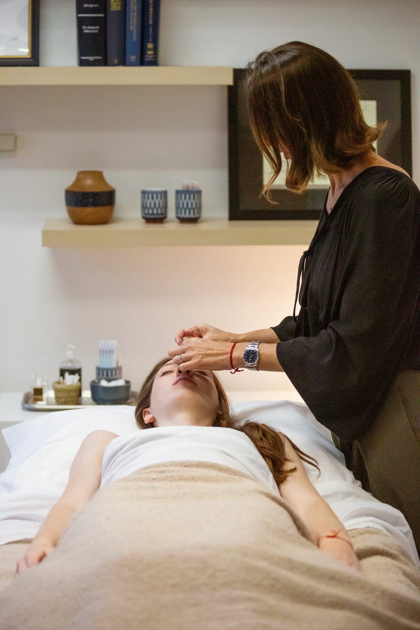 Acupuncture treatment session in a spa setting.