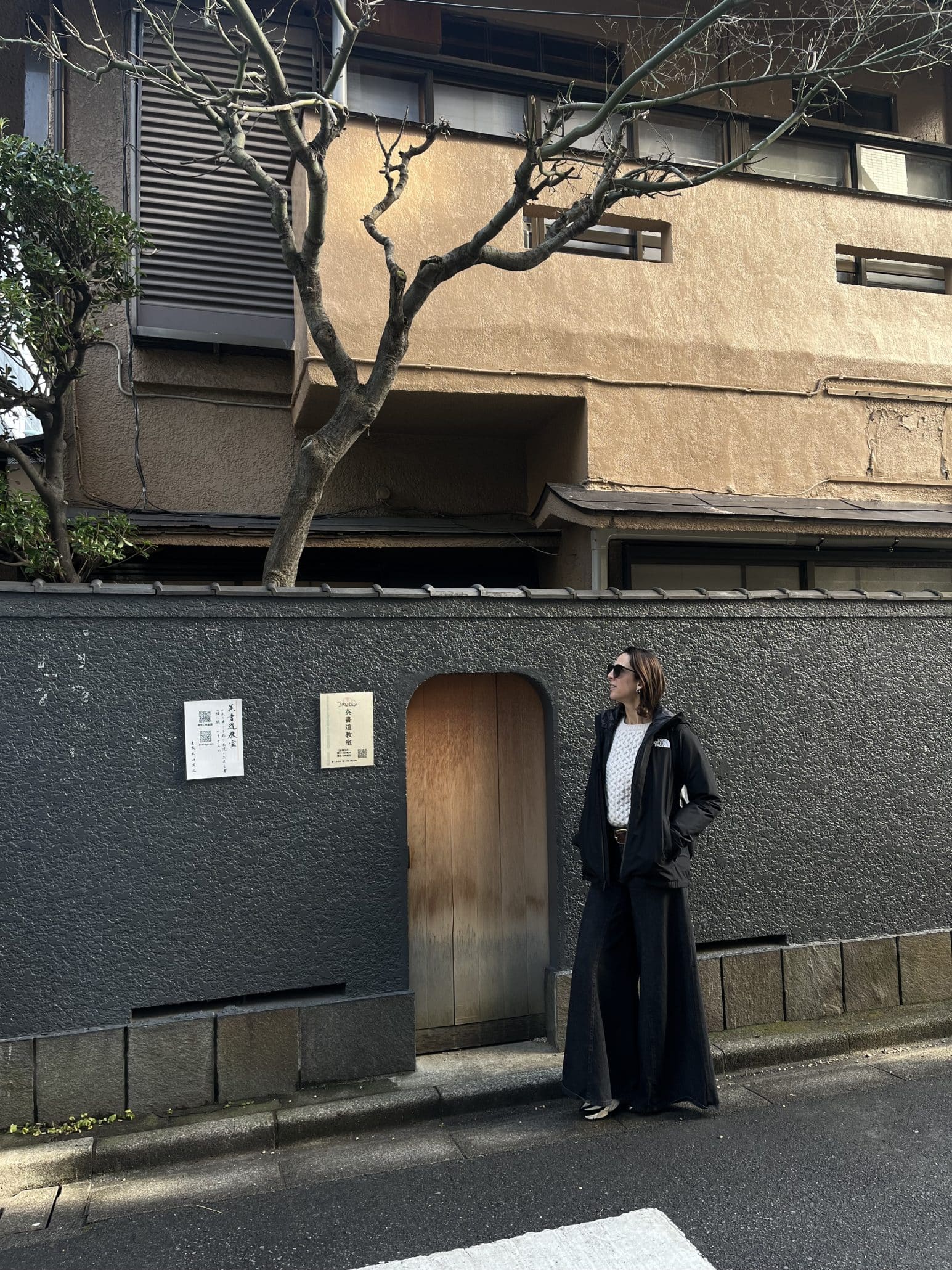 woman standing in front of traditional Japanese building in Kyoto