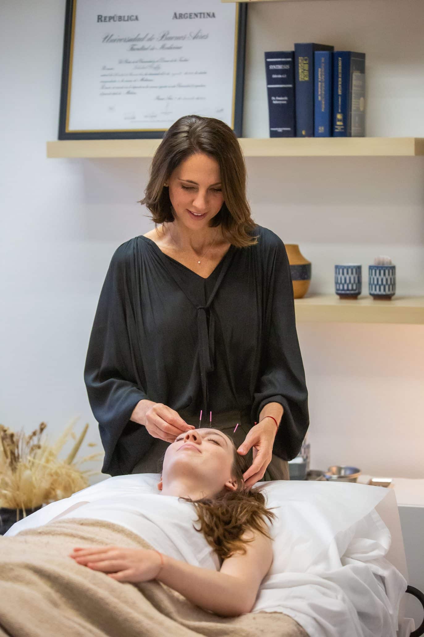 Therapist performing acupuncture on patient.
