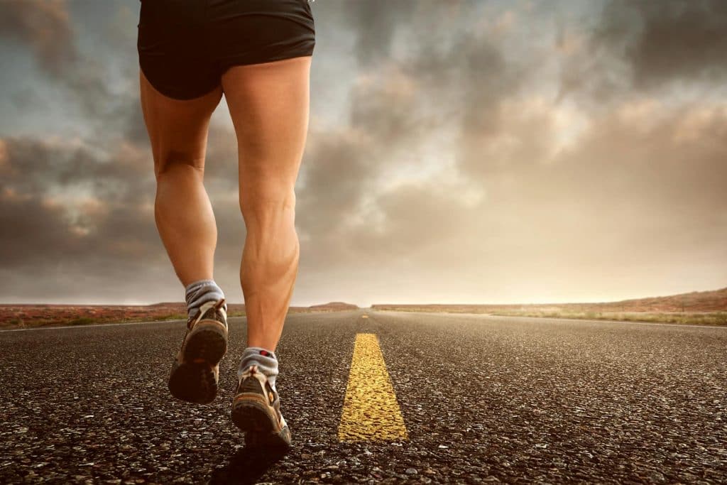 person running on an open road symbolizing pain recovery
